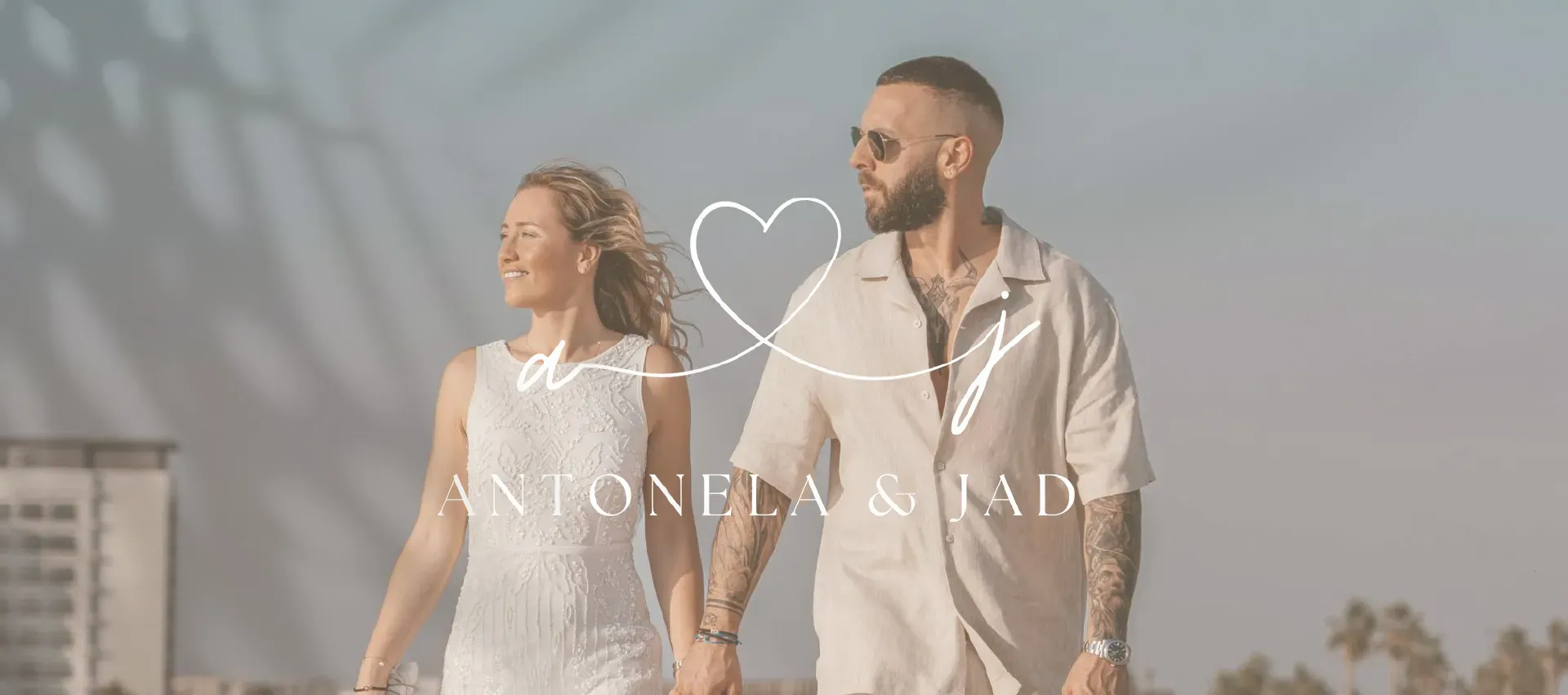 The couple’s monogram over a photo of them walking by the sea.